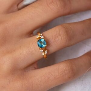 Gold Ring with Blue Gemstone and Diamond Accents